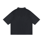 Black vintage-wash lyocell drop-shoulder button-up shirt, pointed collar, short sleeves.