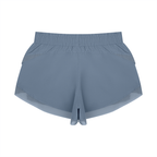 Light blue paneled yoga shorts with wide elastic waistband and layered hem detail.