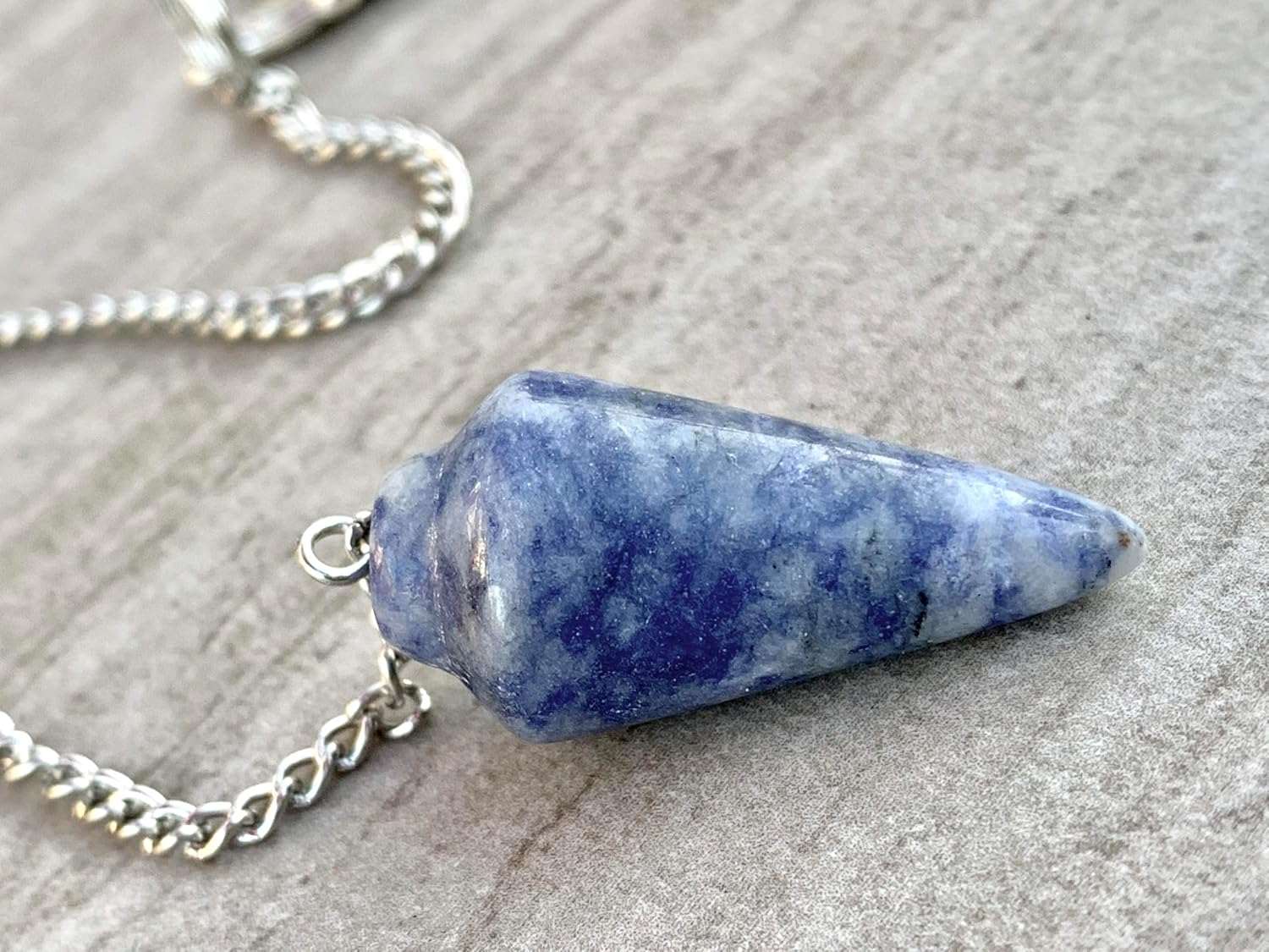 Blue gemstone pendulum bag charm with silver chain and pointed teardrop stone
