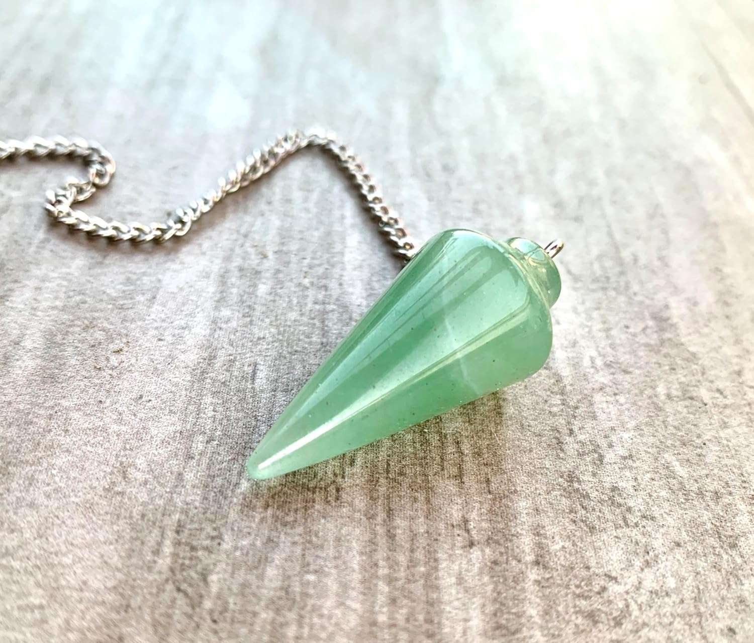 Green aventurine pendulum charm with silver chain and faceted pointed stone