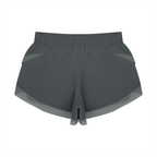 Dark gray paneled yoga shorts with wide elastic waistband and layered hem detail.