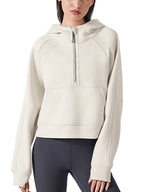 Cropped half-zip hoodie in light cream with ribbed trim and front zip placket