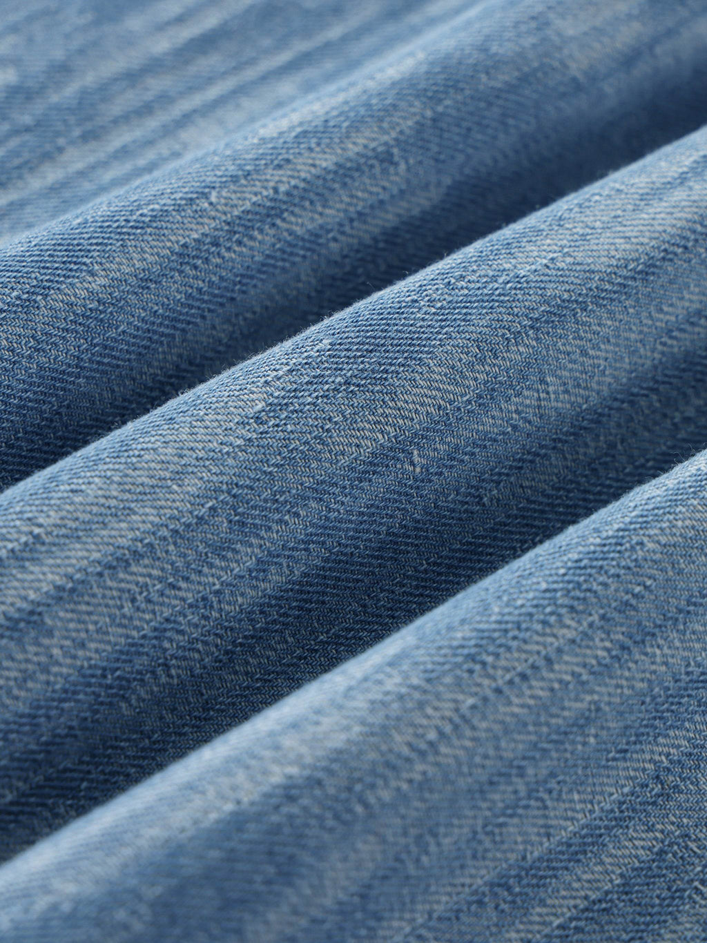 Distressed blue shirt fabric texture and close seam detail