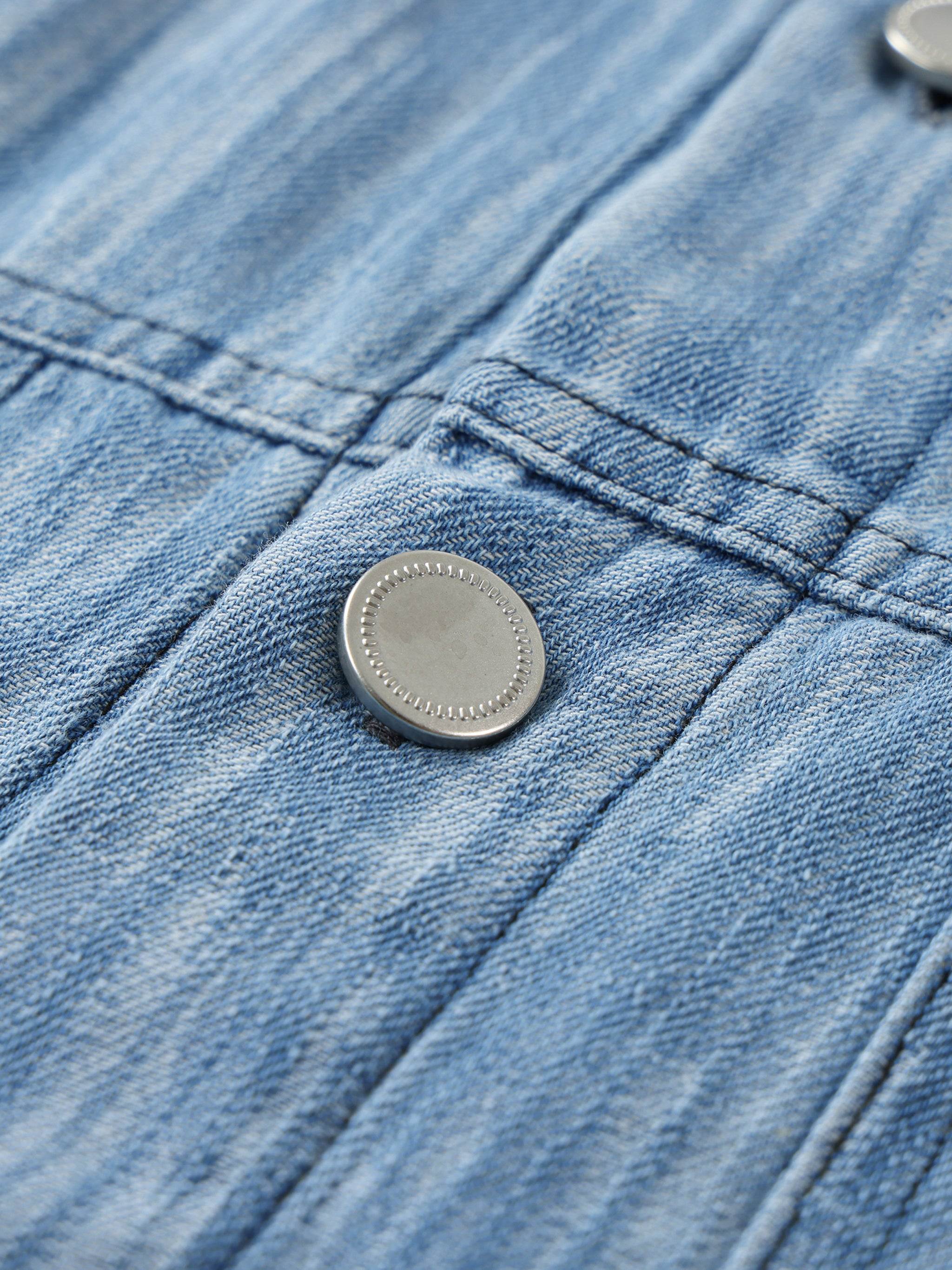 Distressed blue shirt chest button detail with stitched placket