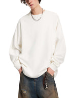 White oversized knit sweatshirt with round neckline, long sleeves, relaxed fit
