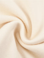 Cream knit fabric close-up with fine textured weave