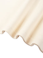 Cream knitted sweatshirt hem with ribbed trim and curved knit edge