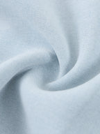 Light blue lyocell fabric texture close-up with soft vintage-wash creases