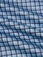 Sky blue plaid fabric texture with crisscross grid pattern