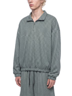 Green plaid quarter-zip sweatshirt with collared neckline and long elastic cuffs