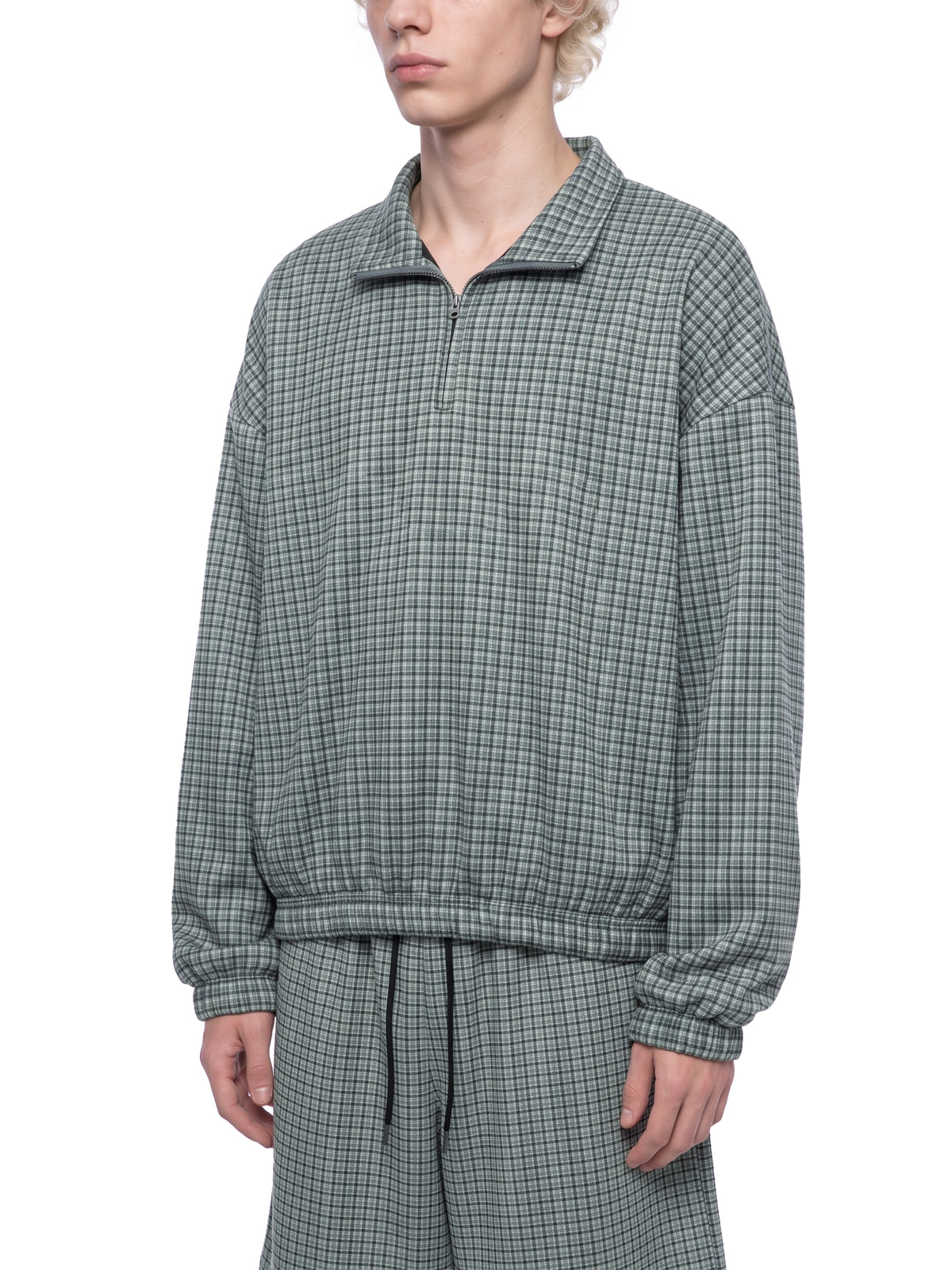 Green plaid quarter-zip sweatshirt with collared neckline and long elastic cuffs