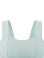 Mint green ribbed crop tank top detail: wide U-shaped neckline and thick shoulder straps.