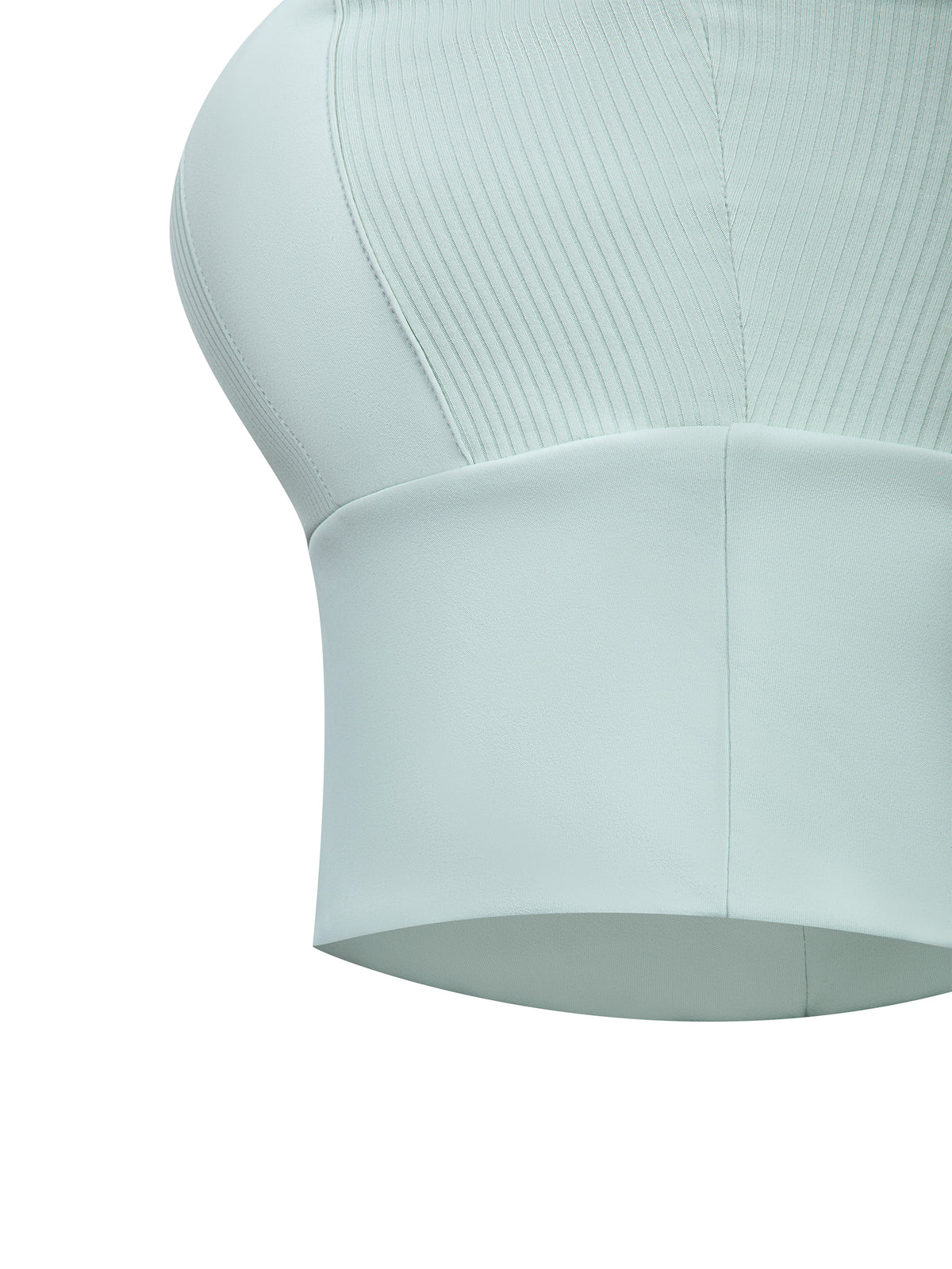 Mint green yoga crop tank top close-up of ribbed fabric and smooth lower panel hem.