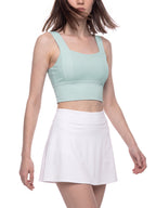 Mint green yoga crop tank top with wide straps, square neckline, and cropped length.