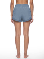 Women’s blue paneled yoga shorts from the back with elastic waistband