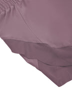 Women’s purple yoga shorts hem with paneled seam and layered underlay