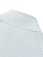Light blue jacket shoulder and collar seam with partial zipper line