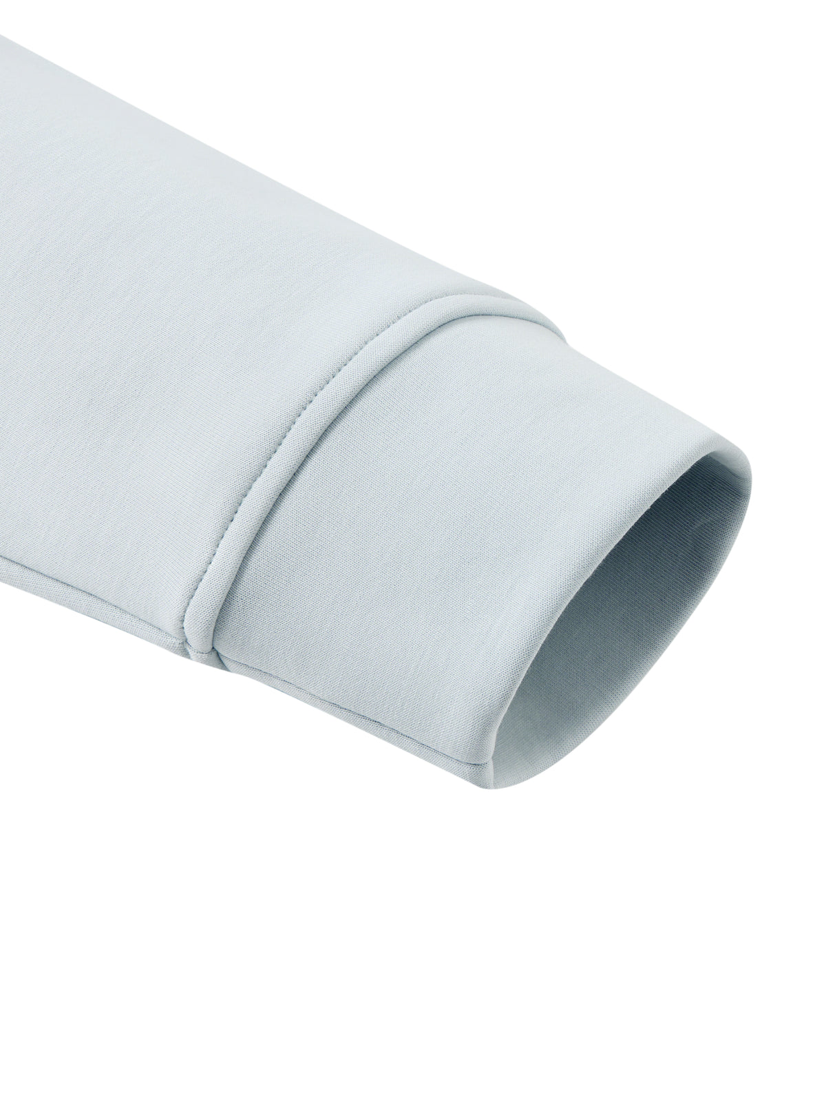 Light blue jacket sleeve cuff with clean stitched hem
