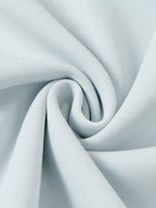 Light blue jacket fabric fold close-up showing soft drape and weave