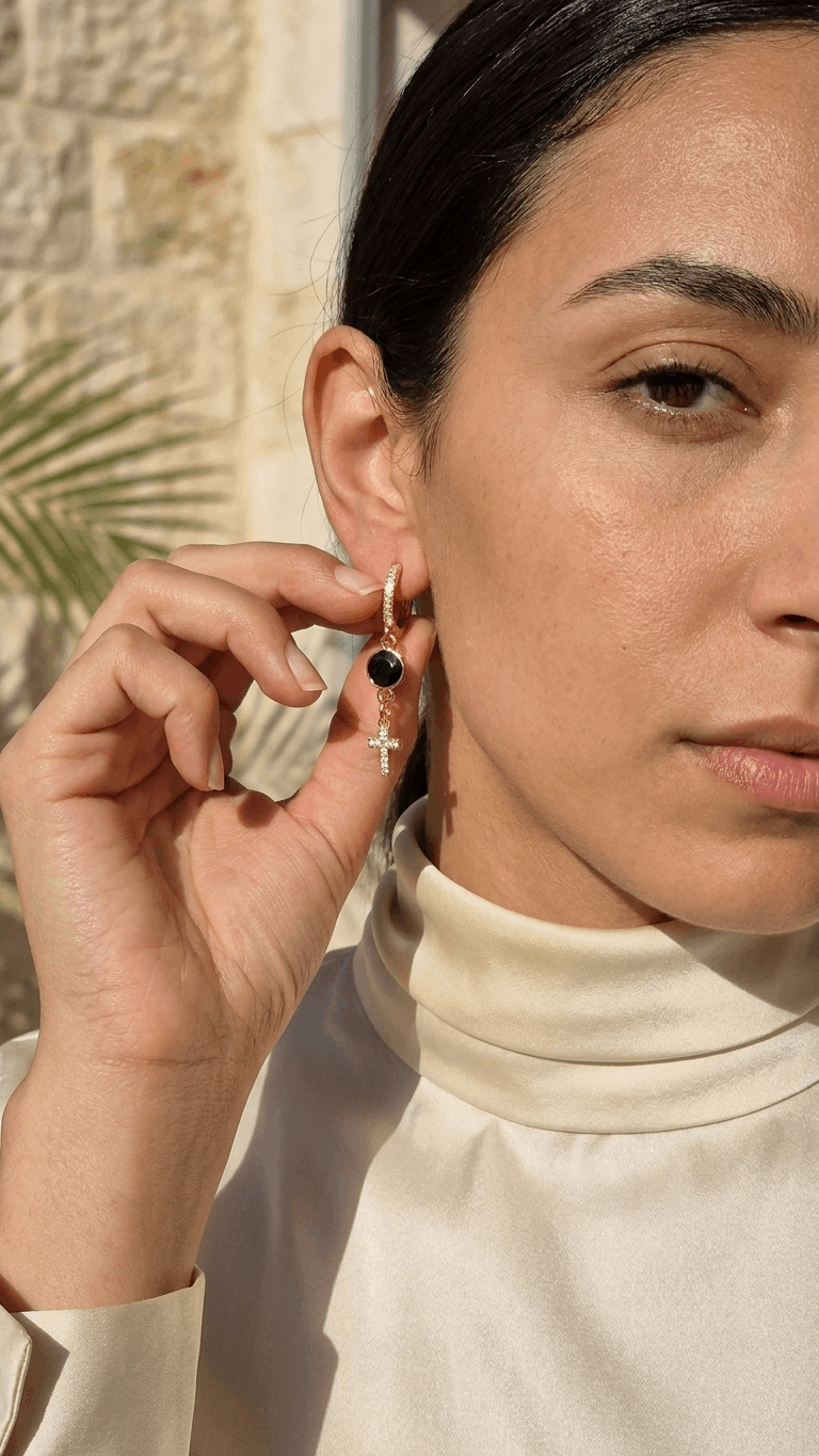 Gold-tone hoop clip earrings with black zircon stone and white zircon cross dangle