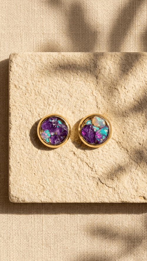 Gold opal stud earrings with purple gemstone center and iridescent bezel