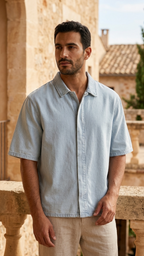 Light blue lyocell short-sleeve button-up with drop shoulders, worn by model