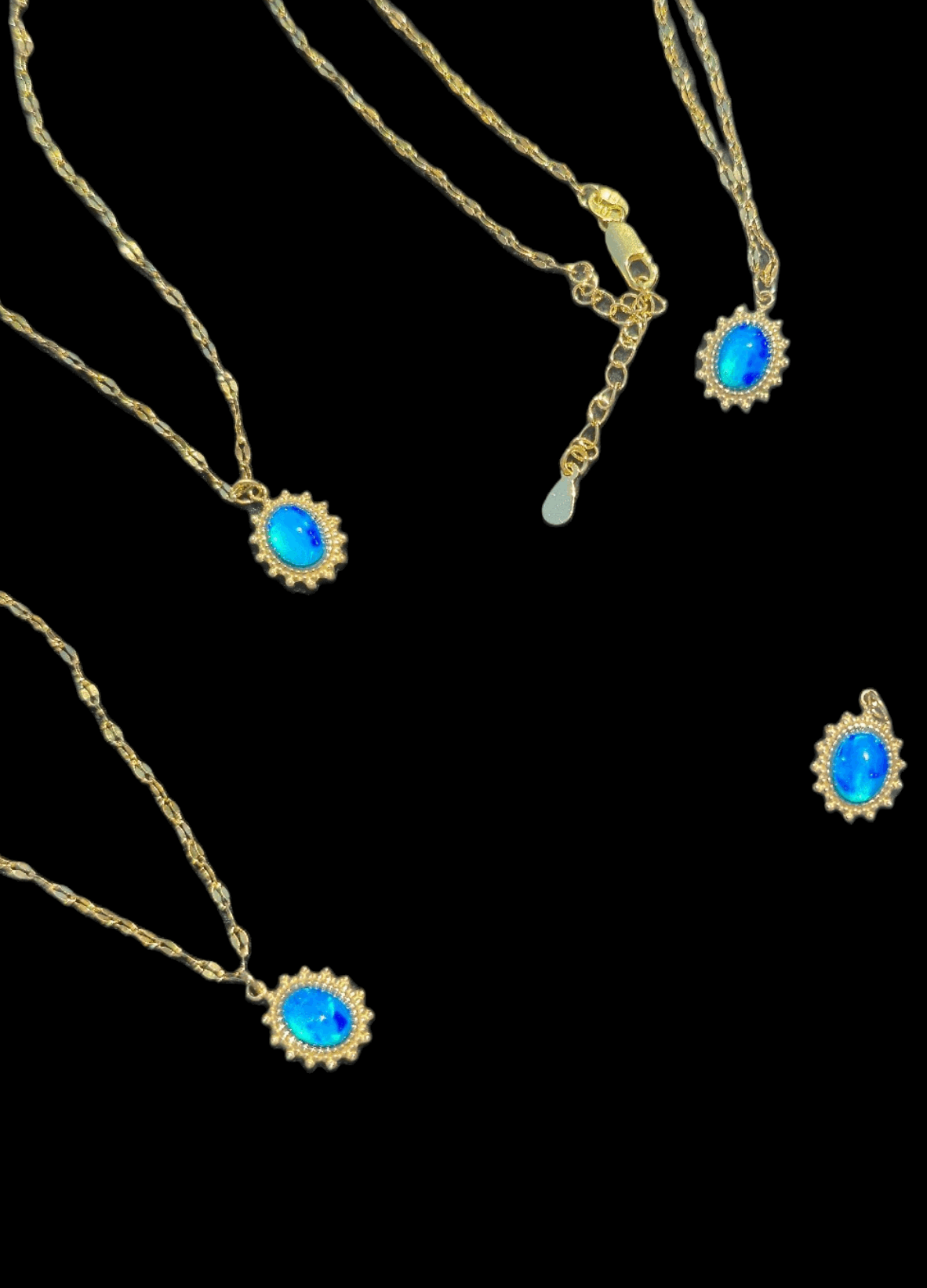 Gold-tone chain with blue opal oval pendant, ornate sunburst bezel