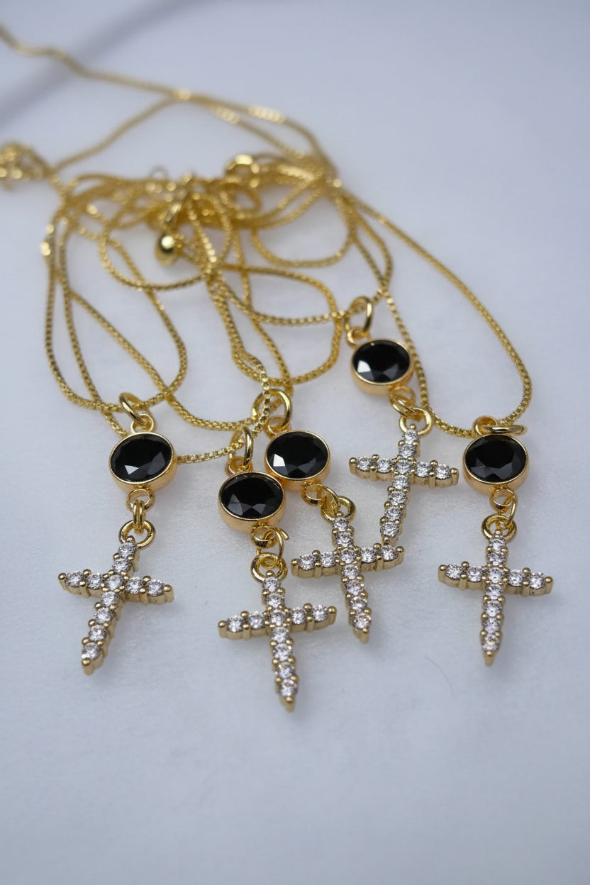 Gold-tone cross necklace with black round stones and rhinestone cross pendants