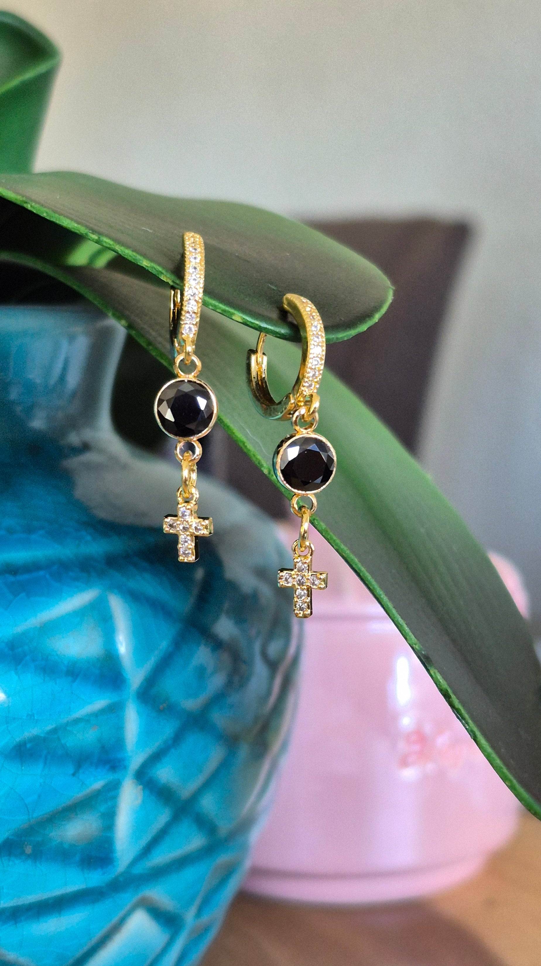 Gold hoop huggie earrings with black round zircon and dangling gold cross charm