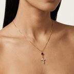 Gold cross necklace with red oval center and white zircon pavé pendant